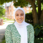 Photo of Rasha Alkhateeb, a woman wearing a hijab, smiling, and looking forward